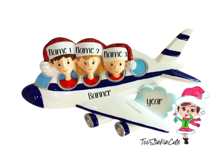 Blue-and-white airplane Christmas ornament with three numbered passengers, a banner, and year on a cloud.