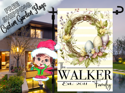 Walker family garden flag with pastel Easter eggs, a twig-and-foliage wreath and pale yellow stripes displayed at dusk.