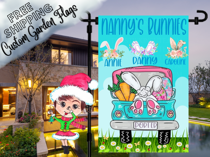 Nanny's Bunnies garden flag with floral bunny-ear motifs, names and a turquoise Easter truck shown at dusk.