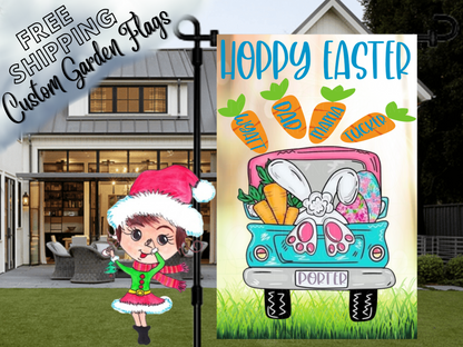 Happy Easter garden flag with a turquoise truck, bunny feet, colorful eggs and named carrots on cream in front of a porch.