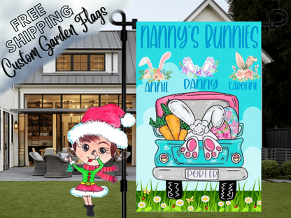 Nanny's Bunnies garden flag with floral bunny-ear motifs, names and a turquoise Easter truck in front of a porch.