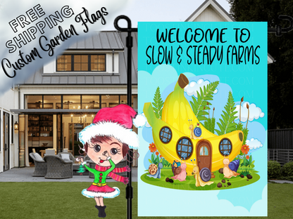 Slow and Steady Farms welcome flag with a yellow cottage, snails and flowers, displayed in front of a porch.