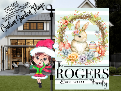 Rogers family garden flag with a flower-crowned bunny, pastel Easter eggs and floral wreath, displayed by a porch.