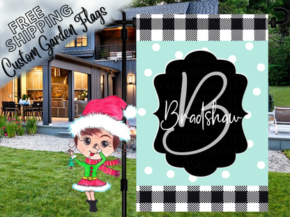 Mint polka-dot Bradshaw family garden flag with a script B monogram, black label and check borders outside a house.