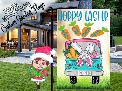 Happy Easter garden flag with a turquoise truck, bunny feet, colorful eggs and named carrots on cream outside a house.