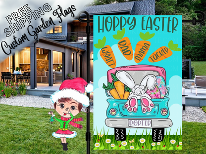 Happy Easter garden flag with a turquoise truck, bunny feet and named carrots, shown outside a house.