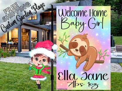 Welcome Home Baby Girl garden flag with a sloth, rainbow background, Ella Jane example name and birth details outside a house.