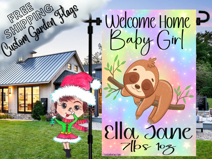 Welcome Home Baby Girl garden flag with a sloth, rainbow background, Ella Jane example name and birth details beside a white house.