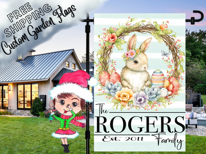Mint striped Rogers family flag with a flower-crowned bunny and Easter-egg wreath, shown beside a white house.