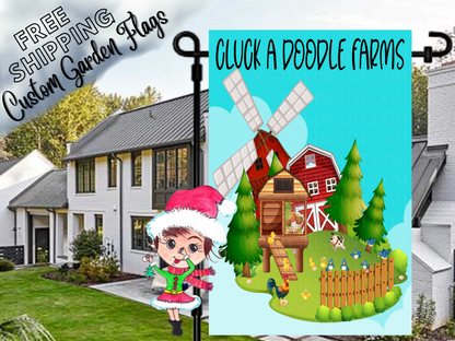 Cluck a Doodle Farms garden flag mockup with a barn, windmill and chicken coop, shown in a daytime yard.