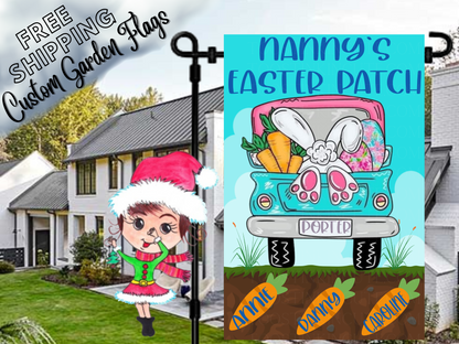 Nanny's Easter Patch garden flag with a turquoise truck, bunny feet and named carrots in soil in a daytime yard.