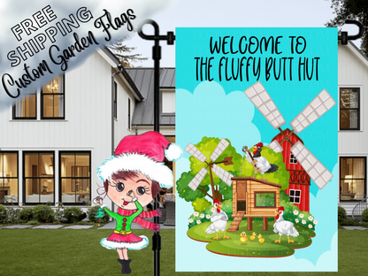 Welcome to the Fluffy Butt Hut flag with chickens, coop and windmills, displayed in front of a porch.