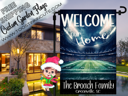 Welcome to Our Home garden flag with a lighted football stadium, green field, Broach family name and Greenville, SC text. Shown outside a house at dusk.