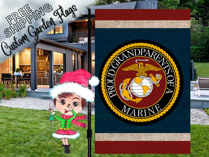 Proud Grandparents of a Marine garden flag with eagle, globe and anchor emblem, navy center and red borders outside a house.