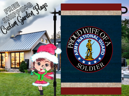 Proud Wife of a Soldier garden flag with Army National Guard emblem, navy background and red borders beside a white house.