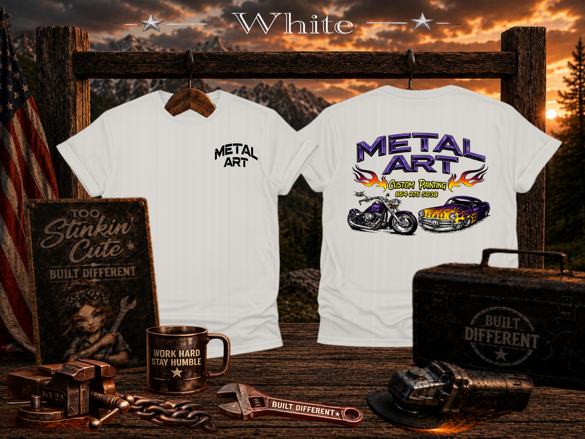 Two white graphic t-shirts displayed on a rustic wooden stand, with a mountain sunset backdrop. The left shirt shows a small black 'METAL ART' logo on the chest, and the right shirt shows a large purple, yellow, and black motorcycle-themed graphic.