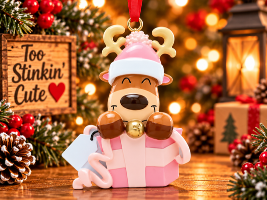 Personalized reindeer Christmas ornament in a pink gift box with a matching pink winter hat and white gift tag.