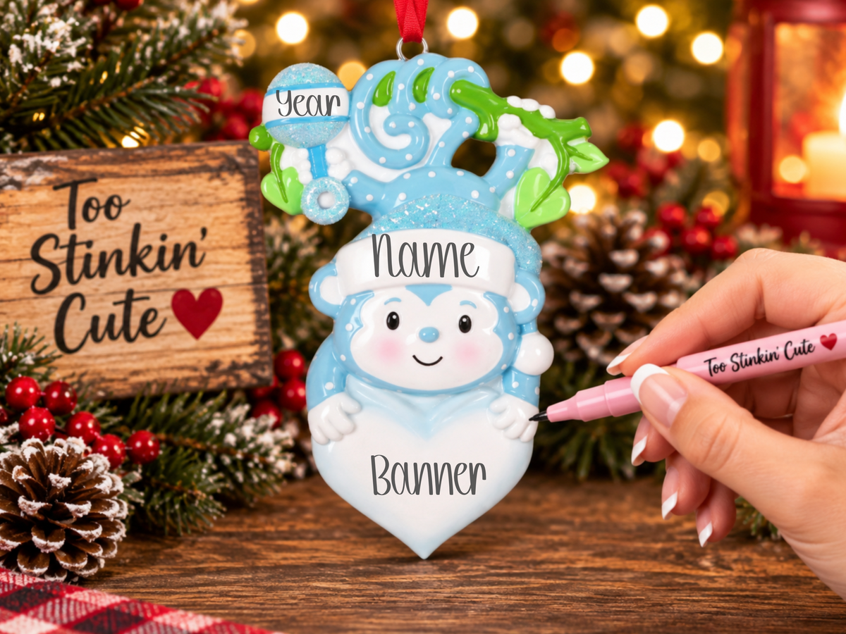 Custom name baby boy ornament with a glittery blue Santa hat and playful details