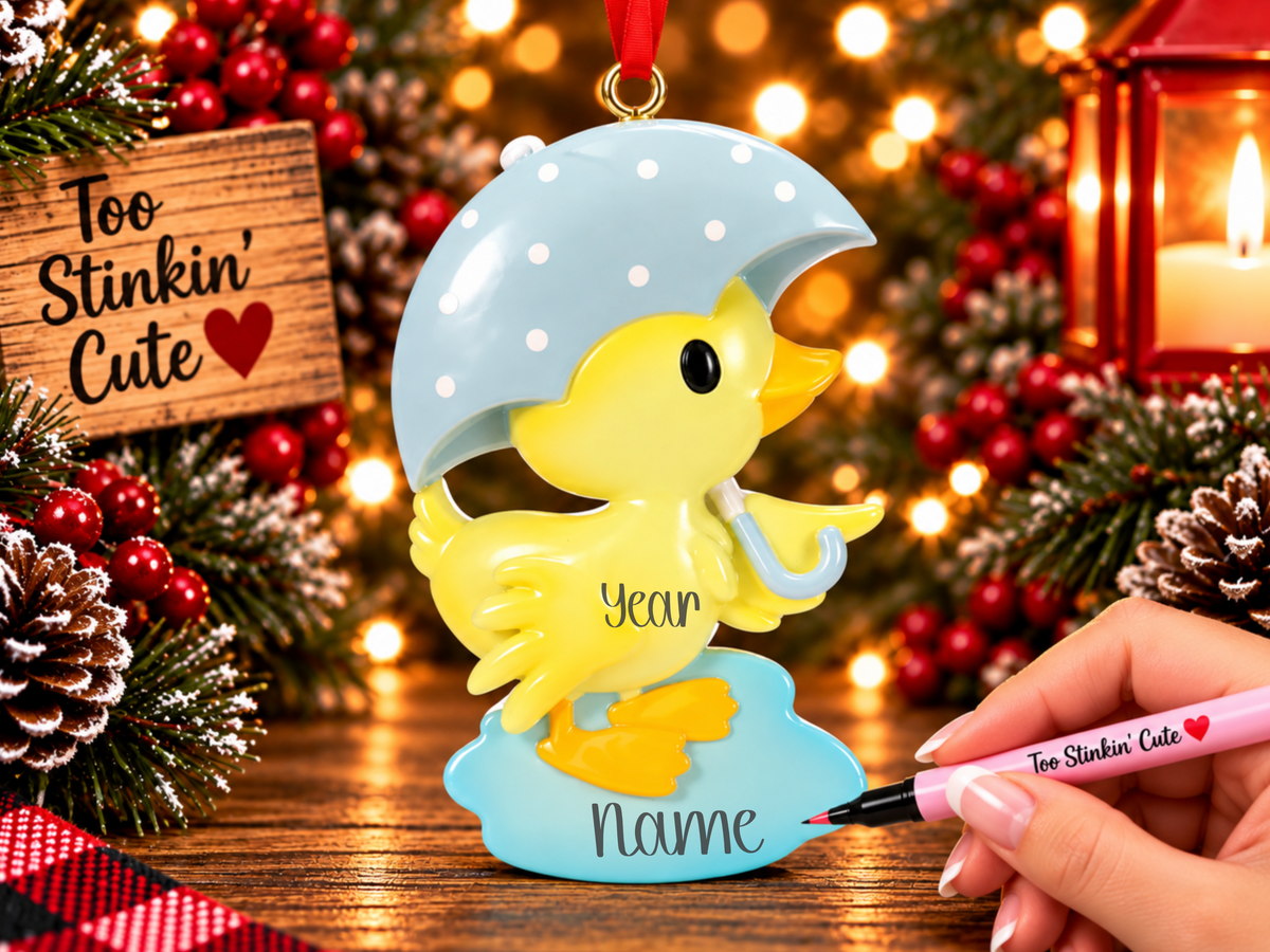 Personalized yellow ducky Christmas ornament holding a light blue polka-dot umbrella with custom name area