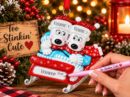 Custom couple ornament with two polar bears riding together on a festive red sled.