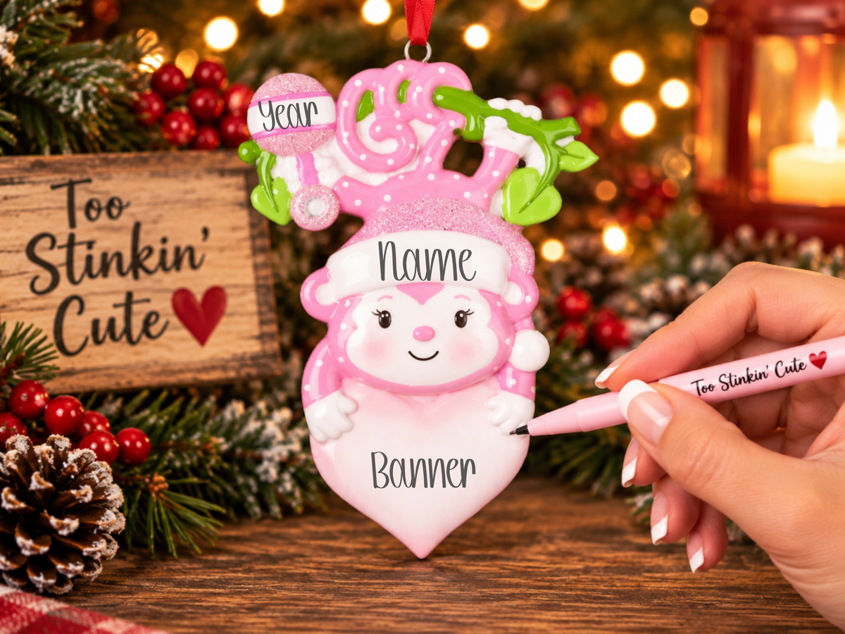 Custom name baby girl ornament with a glittery pink Santa hat and playful details