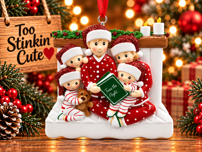 Family of five Christmas ornament featuring two parents and three children gathered around a green storybook.