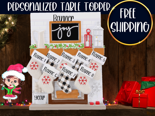 White fireplace table topper with eight numbered Christmas stockings, a joy sign, and banner and year spaces.