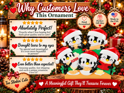Penguin baking ornament with black and white figures, pink cheeks, yellow beaks, and a red hanging ribbon.