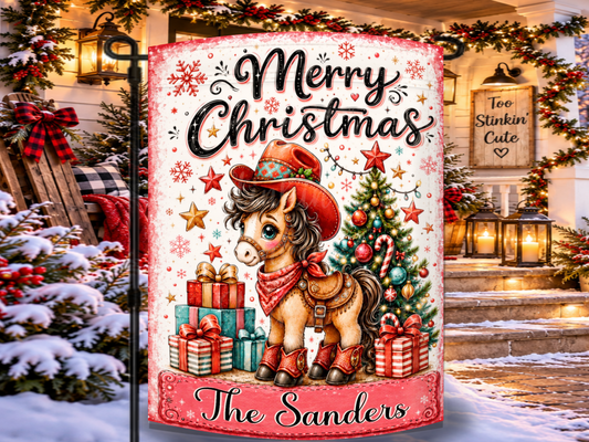 Personalized cowgirl Christmas garden flag featuring a cute pony in a festive western hat, red bandana, saddle, and boots with a custom family name.