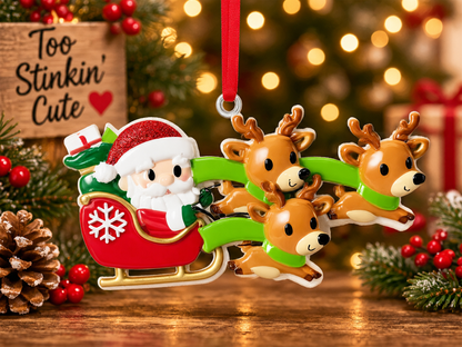 Santa and three reindeer ornament hanging from a red ribbon beside a wooden Too Stinkin’ Cute sign.