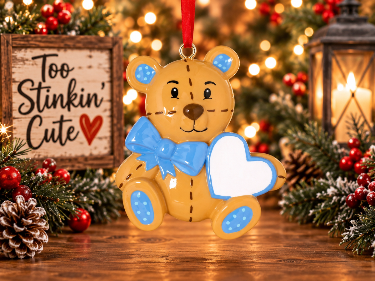 Personalized teddy bear Christmas ornament for a boy with a blue bow and custom name heart