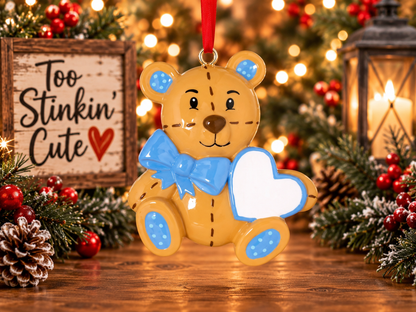 Personalized teddy bear Christmas ornament for a boy with a blue bow and custom name heart