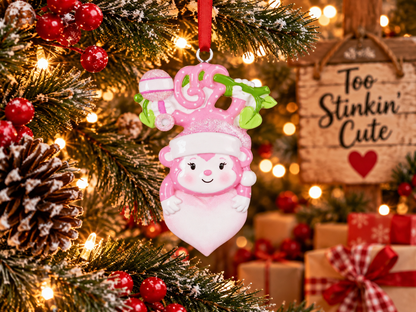 Custom pink resin Christmas ornament hand-personalized with a baby’s name