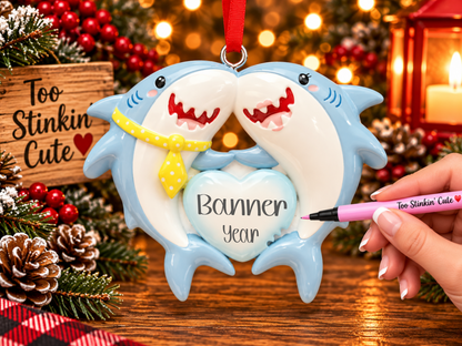 Shark couple ornament with a yellow polka dot tie on the left shark and eyelashes on the right shark.