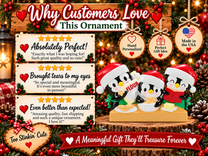 Penguin baking family of three ornament hanging from a red ribbon against warm Christmas lights.