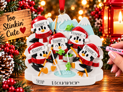 Five black and white penguins gathered around a blue ice fishing hole with green fish and orange fishing poles.