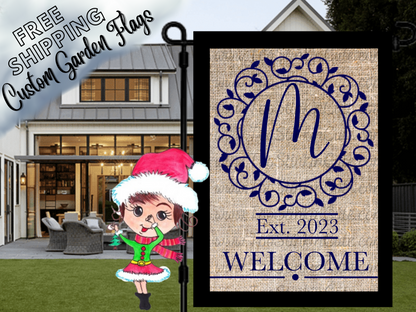 Burlap-look garden flag mockup with a blue script monogram, ornate circular frame and welcome message.
