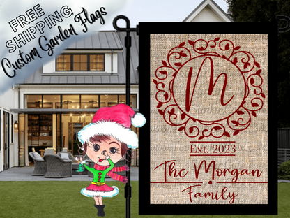 Burlap-look garden flag mockup with a red M monogram, ornate circular frame, establishment year and Morgan family name.