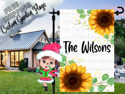 White wood-print garden flag mockup with bright yellow sunflowers and Wilson family-name lettering.