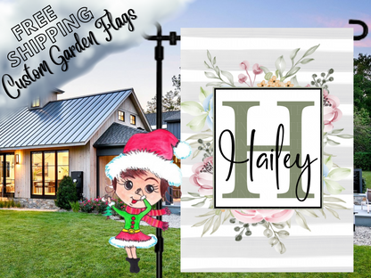 Gray striped garden flag mockup with a sage H monogram, Hailey name and pastel floral wreath.