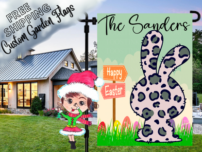Easter garden flag mockup with a leopard-print bunny, family name, colorful eggs, green grass and Happy Easter sign.