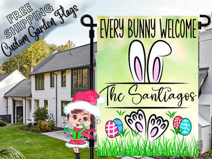 Green Every Bunny Welcome garden flag mockup with white bunny ears and feet, colorful eggs and Santiago family name.