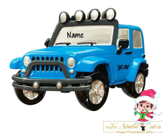 Christmas Ornament showing blue off-road SUV with black tires and roof-mounted lights.