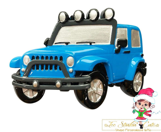 Christmas Ornament showing blue off-road SUV with black tires and roof-mounted lights.
