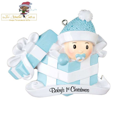 Christmas Ornament showing baby boy emerging from a blue-and-white present and blue bow and rattle.