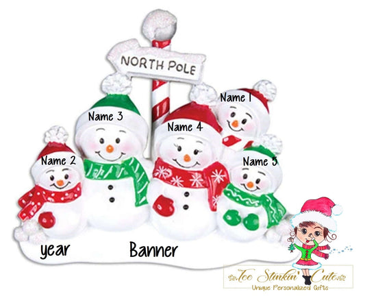 Family of 5 table topper with snowmen gathered around a striped North Pole sign. Sample personalization labels are shown.