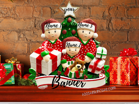 Pajama family of three table topper beside a Christmas tree and gifts, with numbered names, banner, and year labels.