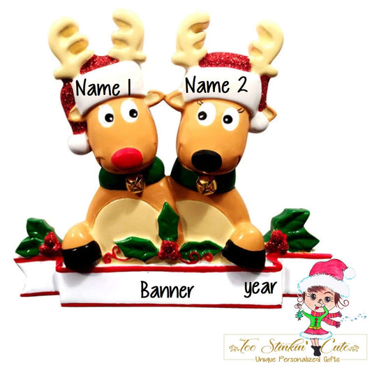 Family of 2 table topper with Santa-hat reindeer gathered above a white banner. Sample personalization labels are shown.