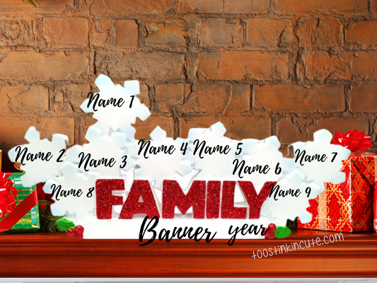 Family of 9 table topper with white snowflakes above glittery red FAMILY lettering. Sample personalization labels are shown.